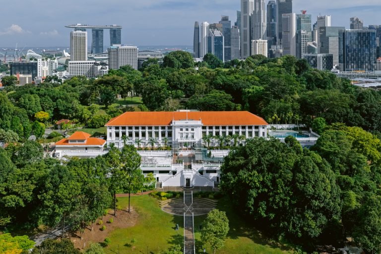 METT Singapore, part of Sunset Hospitality Group, in Fort Canning Park with the city skyline behind.