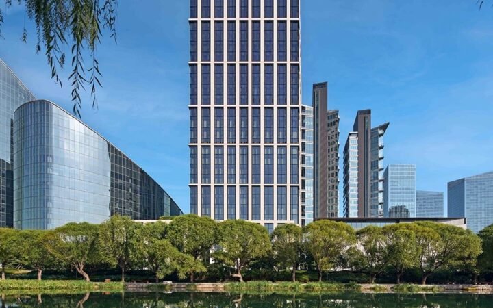 Bvlgari Hotel Beijing and riverside gardens reflected in the Liangma River