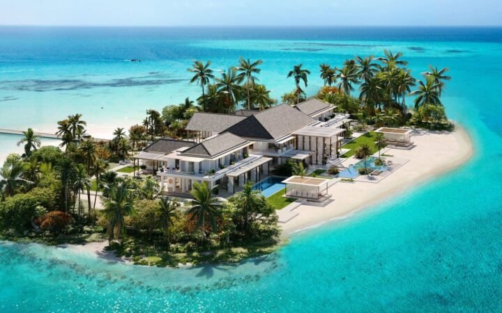 Official rendering of an island residence at Baccarat Maldives, surrounded by palm trees and turquoise water.