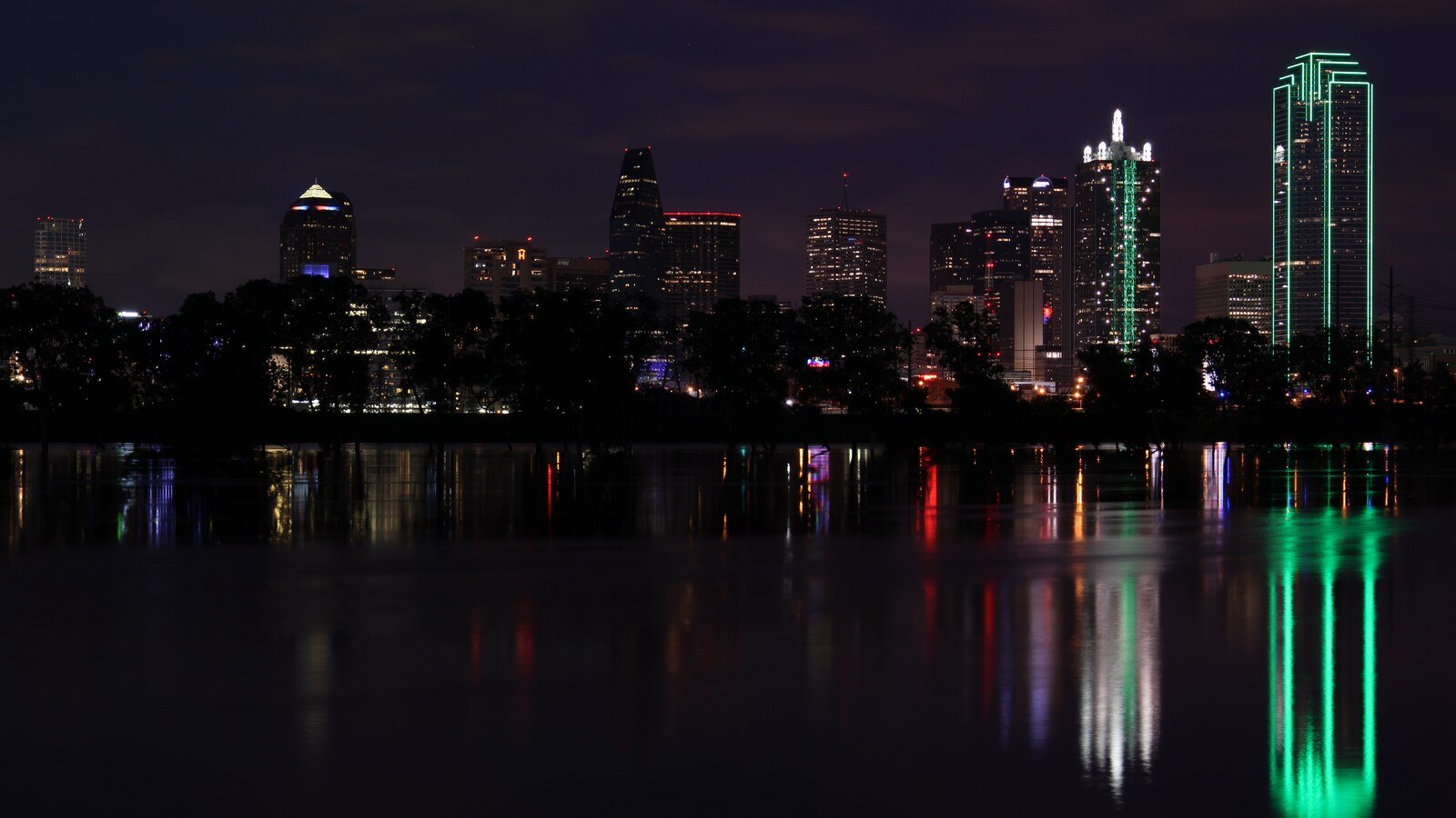 Illustrative archive photograph of Dallas’s illuminated skyline reflected across the Trinity River at night in 2015.