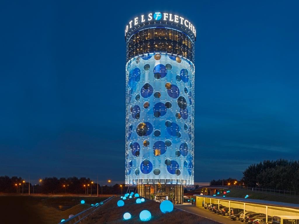 Fletcher Hotel Amsterdam at night, illustrating the Sunday PropTech acquisition agreement