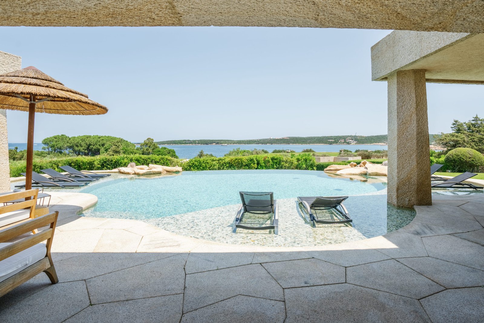 Private pool and sun loungers overlooking the sea at Hotel Pitrizza’s three-bedroom Pitrizza Pool Villa.